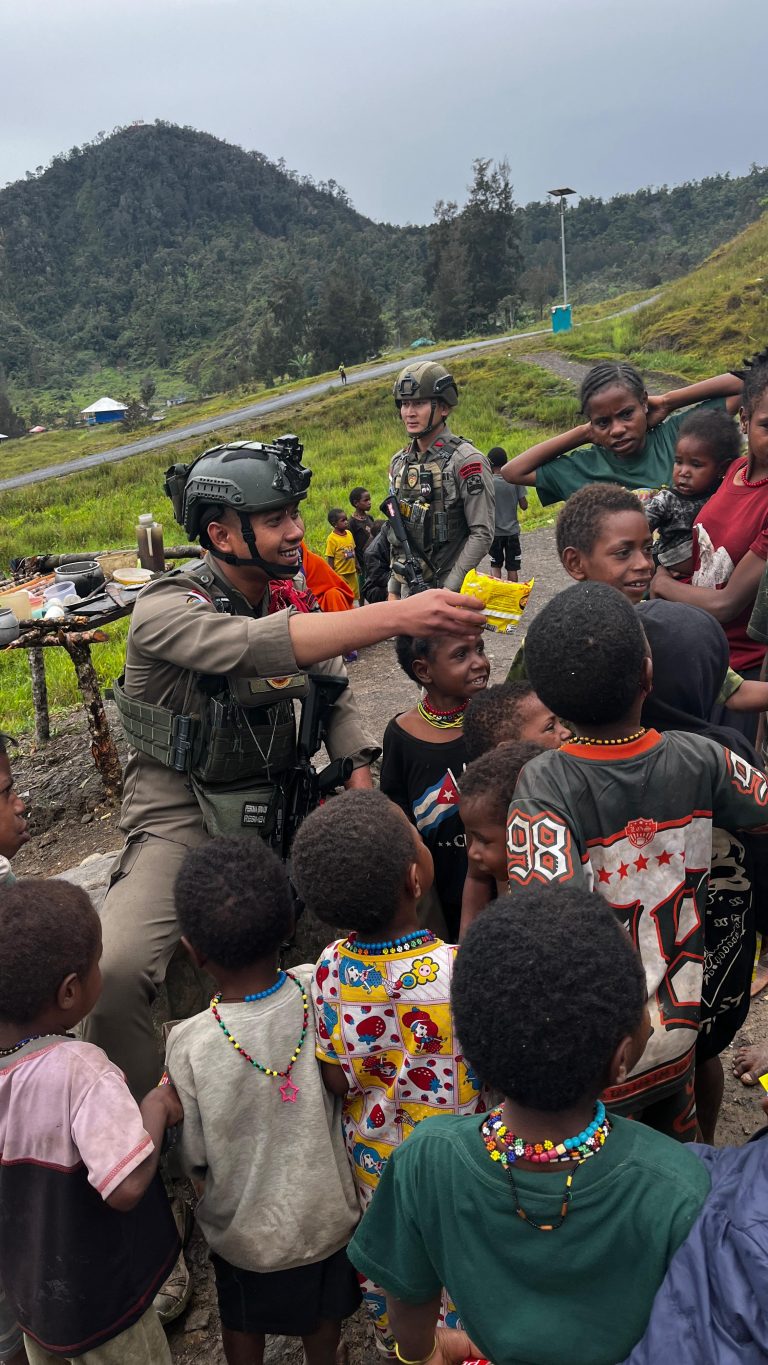 Personel Ops Damai Cartenz Sektor Sinak Beri Mi Instan dan Makanan Ringan Saat Warga Membersihkan Gereja Gingga Baru